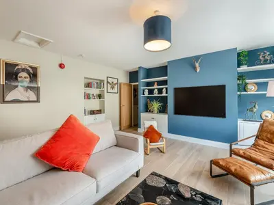 a living room with a couch and a tv at Station Street Apartment in Cockermouth