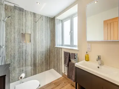 a bathroom with a sink and a shower at Station Street Apartment in Cockermouth