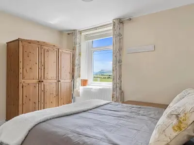 a bedroom with a large bed and a window at Newly Renovated 2 Bed Property - Pass the Keys in Cleator Moor