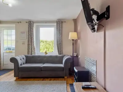 a living room with a couch and a table at Newly Renovated 2 Bed Property - Pass the Keys in Cleator Moor