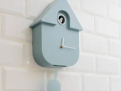 a blue clock is hanging on a wall at Newly Renovated 2 Bed Property - Pass the Keys in Cleator Moor