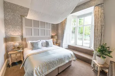 a bedroom with a large bed and a window at Forest Side Hotel in Grasmere