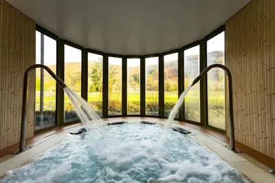 a hot tub in a room with windows at Rothay Garden by Harbour Hotels in Grasmere