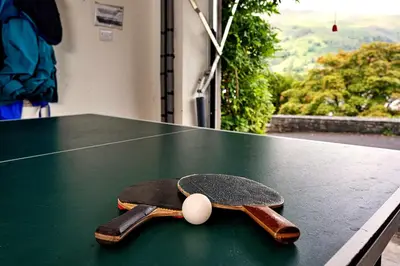 a skateboard and a tennis ball on a table at Finest Retreats - Unerigg in Grasmere