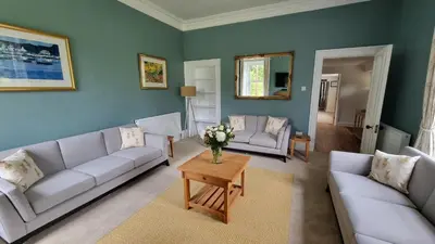 a living room with two couches and a table at Lady Farm - Bargany in Girvan