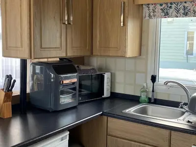 a kitchen with a microwave and a sink at 19 Forest Views in Plumbland