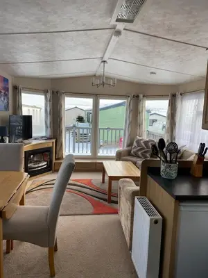 a living room with a couch and a table at 19 Forest Views in Plumbland