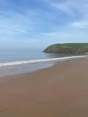 a sandy beach with the ocean in the background at 19 Forest Views in Plumbland