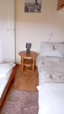 a bedroom with two beds and a table with a lamp at Baytree Lodge at three lochs holiday park, NEW ASK ABOUT OUR PACKAGES birthday ,anniversary,family,pamper packages available in Balminnoch