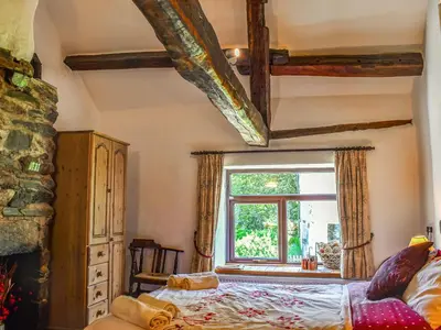 a bedroom with a bed and a window at Church House in Ulpha