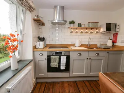 a kitchen with a sink and a stove at Style Cottage in Keswick