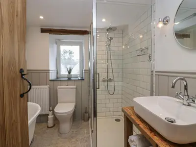 a bathroom with a sink and a toilet and a shower at Style Cottage in Keswick