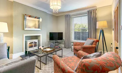 a living room with a couch and a table at Pippin Cottage in Keswick