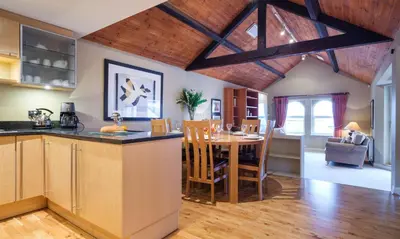a kitchen and dining room with a table and chairs at Underscar - Manesty in Keswick