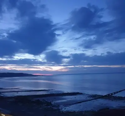 a large body of water with a cloudy sky at The Old Cornstore a beautiful Suite overlooking the sea in Drummore