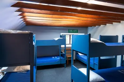 a room with several bunk beds and a ceiling at Weirside, Chapel Stile in Ambleside
