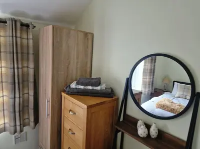 a bedroom with a mirror on top of a dresser at The Old Bank at St Bees, Western Lakes in St Bees