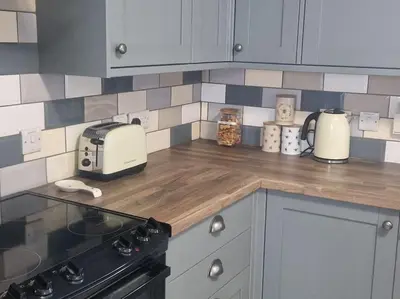 a kitchen with a counter top with a toaster and a stove at The Old Bank at St Bees, Western Lakes in St Bees