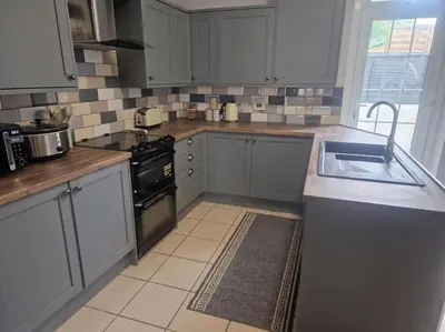 a kitchen with a sink and a stove top oven at The Old Bank at St Bees, Western Lakes in St Bees