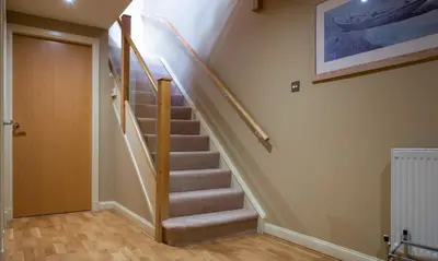 a staircase in a home with a stair case at Underscar - Beckstones in Keswick