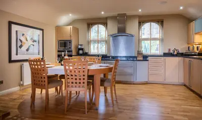 a kitchen with a table and chairs in a kitchen at Underscar - Beckstones in Keswick