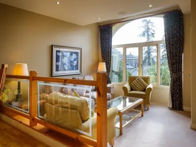 a living room with a couch and a table at Underscar - Grange in Keswick