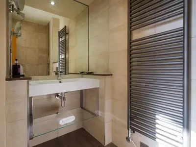 a bathroom with a sink and a mirror at Underscar - Grange in Keswick