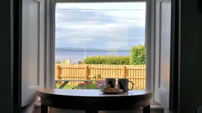 a table in front of a window with a view at Little Egret in Carsethorn