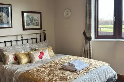a bedroom with a bed with towels on it at wonderful 4 bedroom cottage sleeps 8 in Carlisle
