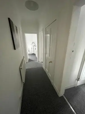 an empty hallway with a white door and a hallwayngthngthngthngthngthngth at DG1 1ST Floor Flat in Dumfries