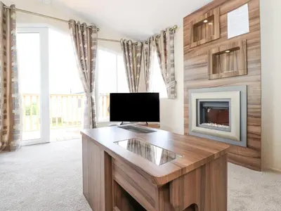 a living room with a television and a fireplace at 31 Forest Views in Cockermouth