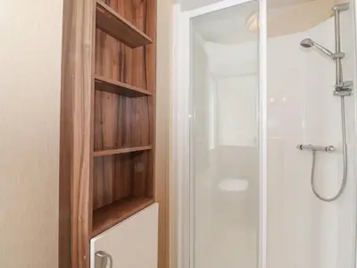 a bathroom with a shower and a glass door at 31 Forest Views in Cockermouth