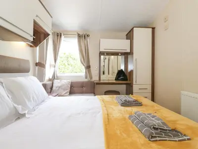 a bedroom with a bed with two towels on it at 31 Forest Views in Cockermouth