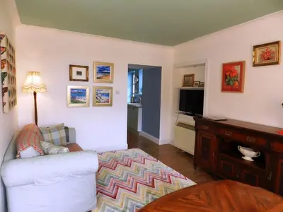 a living room with a couch and a television at Castleside Croft in Kildonan