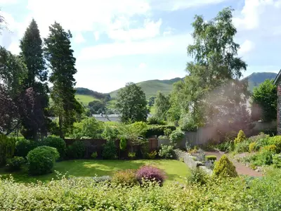 a garden with a view of mountains in the background at Oakvale - Oak Leaf in Braithwaite