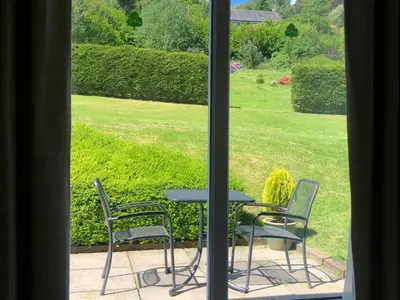 a table and chairs sitting outside a window at Oakvale - Acorn in Braithwaite