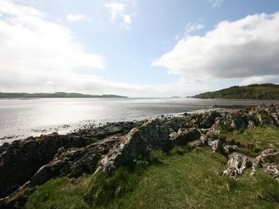 a view of the shoreline of a beach at Rowan Cottage in Borgue