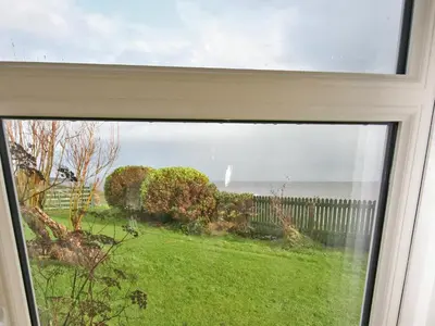 a view of the ocean from a window at East Cottage in Mainsriddle