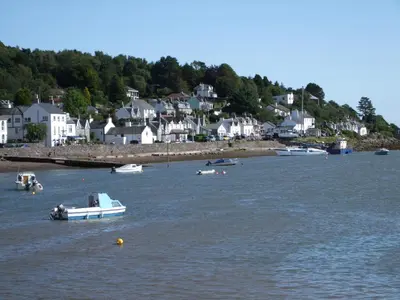 a group of boats in a body of water with houses at Forest Lodge in Dumfries