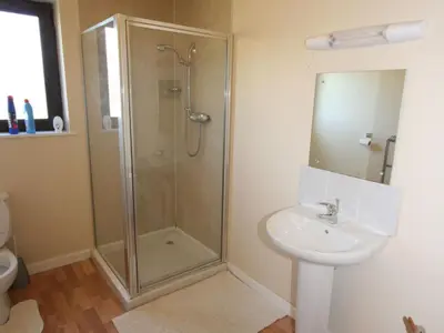 a bathroom with a shower and a sink at Rocky Knowe in Dalbeattie