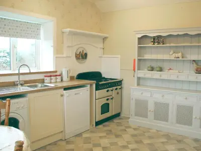 a kitchen with a sink and a stove at Palmallet Cottage in Whithorn