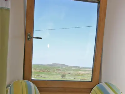 a glass door with a view of a field at Cairndoon Steading Whithorn in Carleton