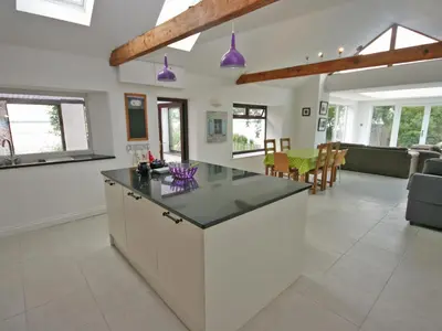 a kitchen with a large island in a living room at Dornock Brow Cottage in Dornock