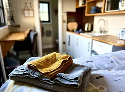 a towel sitting on top of a bed in a kitchen at Herdie Hideaway - Shepherds Hut in Wigton