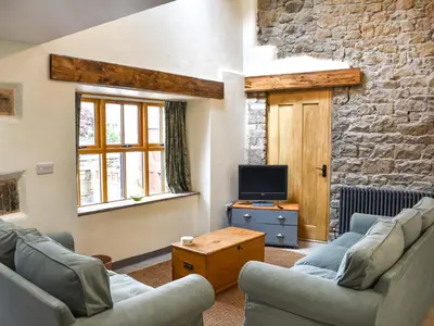 a living room with two couches and a tv at Pickles Barn in Ireby