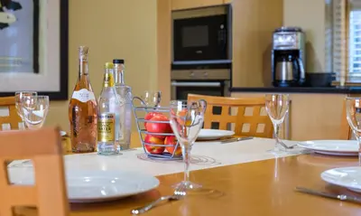 a table with glasses and bottles of wine on it at Underscar - Littledale in Keswick