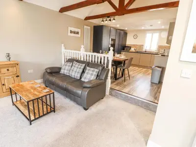 a living room with a couch and a table at Squirrel Cottage in Penrith