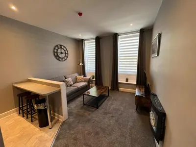 a living room with a couch and a table at The Globe Apartments and Bedrooms in Cockermouth