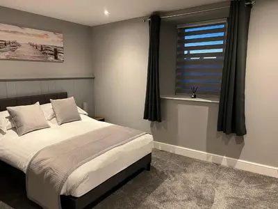 a bedroom with a bed and a window at The Globe Apartments and Bedrooms in Cockermouth