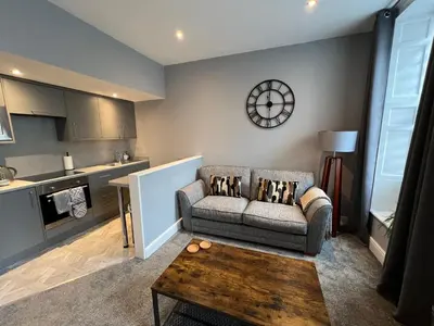 a living room with a couch and a table at The Globe Apartments and Bedrooms in Cockermouth